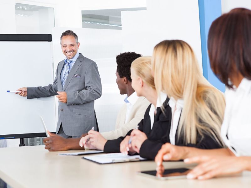 businesspeople looking at businessman